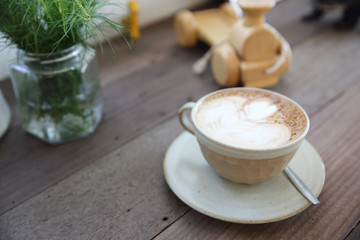 Obraz na płótnie Canvas cappuccino coffee on wood background