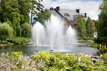 Fototapeta na wymiar Beautiful fountains on lake at botanical garden