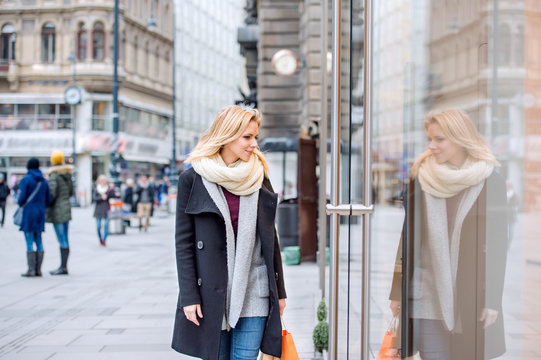 Woman Window Shopping In Centre Of The City. Winter