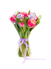 Bouquet of pink tulips and grass on green background