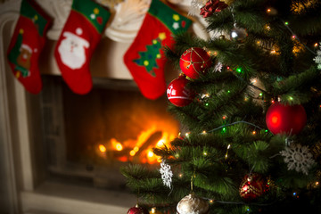 Background of Christmas tree at living room with burning firepla