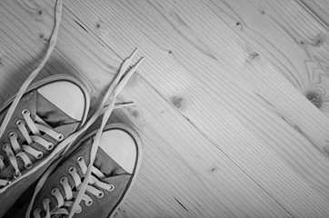 Sneakers on wooden background. Black and white image.