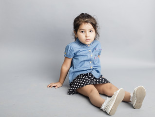 Naklejka premium Small girl playing and posing isoated inside studio