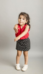 Small girl playing and posing isoated inside studio