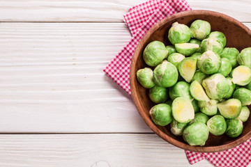 Fresh brussel sprouts over rustic wooden texture.healthy food