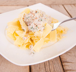 Pappardelle with chanterelle and creame being eaten with a fork