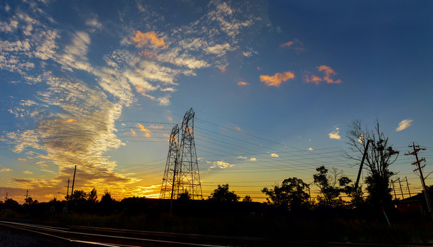 High voltage power pylons in sunset scene twilight