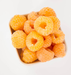 Raspberries: a bowl of fruit on white background