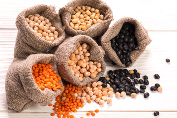 Bowls of various legumes on wooden background,healthy food,vegan food.