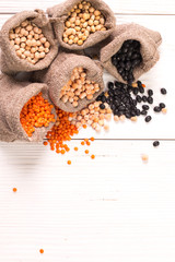 Bowls of various legumes on wooden background,healthy food,vegan food.