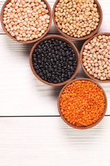 Bowls of various legumes on wooden background,healthy food,vegan food.