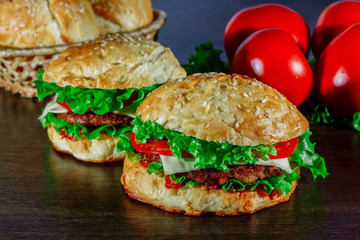 Close-up of home made tasty burgers on wooden table