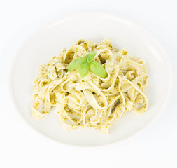Tagliatelle with pesto decorated with basil