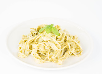 Tagliatelle with pesto decorated with basil