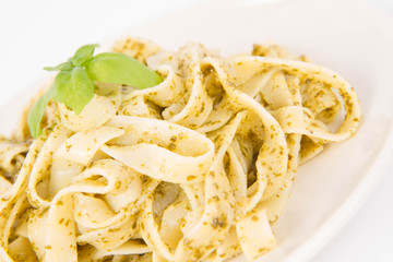 Tagliatelle with pesto decorated with basil