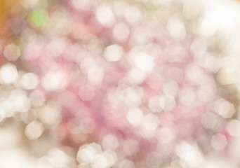 Blurred pale reddish background with bokeh lights