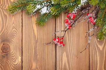 Christmas wooden background with snow fir tree and decor