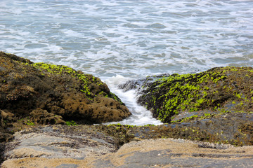 Fototapeta na wymiar Waves of the sea between rocks