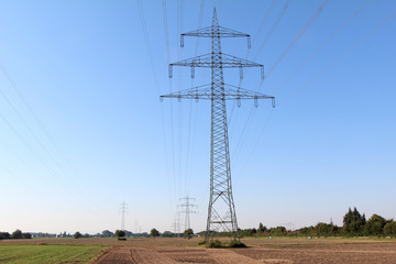 Masts power against the blue sky
