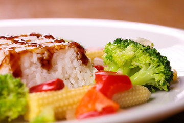Portion of chicken meat with mushroom sauce served with risotto