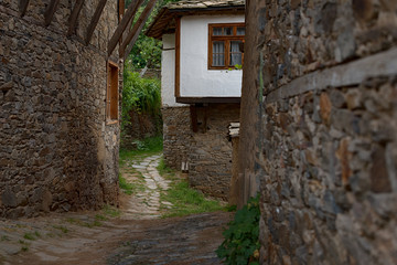 Fototapeta na wymiar Summer time along the streets of Kovachevitsa village, Bulgaria