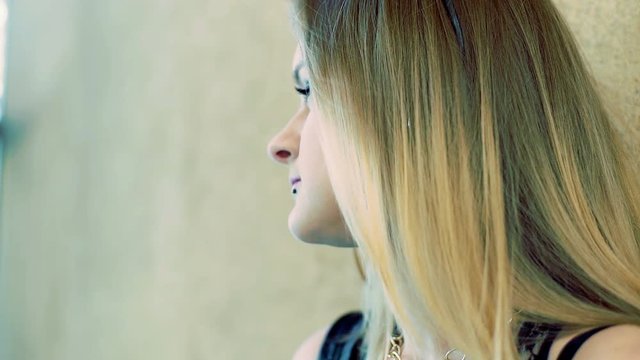 Pretty, punk girl chewing a gum and looking to the camera
