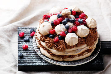 meringue cake with chocolate mousse and berries