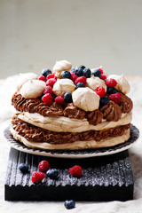 meringue cake with chocolate mousse and berries