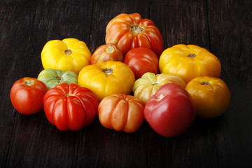 colorful tomatoes on wooden background