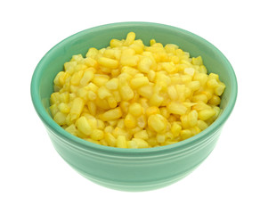 Shoepeg white corn with a butter sauce in a bowl on a white background.