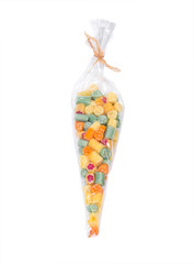 Hard home made all natural candies in skinny plastic sleeve on white background