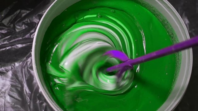 The process of mixing white paint with a color tinge in the bucket drill with a special nozzle prevents paint.