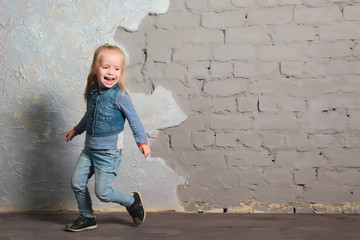 Cute little girl dancing, jumping, smiling and posing to camera