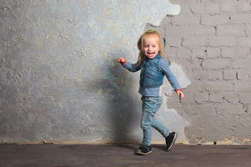 Cute little girl dancing, jumping, smiling and posing to camera