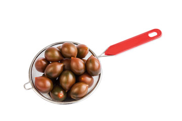 Cherry tomatoes in strainer, ready to wash. Isolated over white background