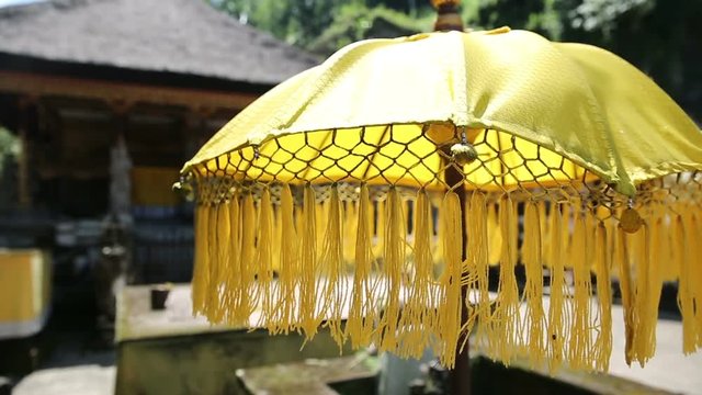 Traditions umbrella on the island of Bali Indonesia. Yellow Traditions Umbrella in Gunung Kawi Is An 11Th Century Temple Complex In Tampaksiring North East Of Ubud, Bali Indonesia