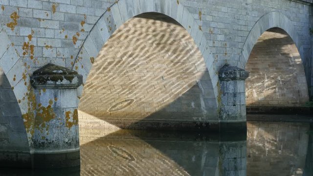 Ancient stone bridge reflection in river surface 4K 2160p 30fps UltraHD footage - Sun shine and bridge reflecting on water 4K 3840X2160 UHD video 