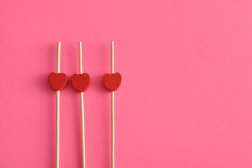 Valentine's Day. Three red hearts on sticks