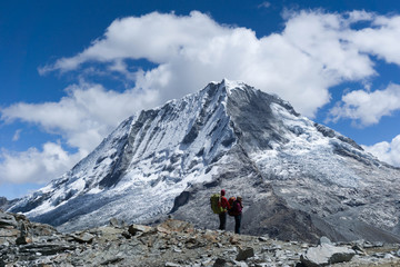 two hikers in the Cordillera Blanca with Ranrapalca Peak in the background
