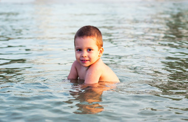 Fototapeta na wymiar Happy child in sea water