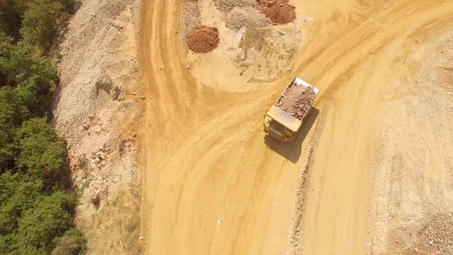 Drone captures the movement of heavy truck in the mine moving in perfect trajectory