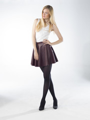 young blonde women with leather skirt in studio