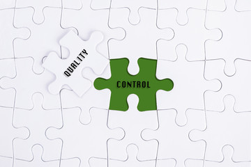 Missing white puzzle with QUALITY CONTROL  word and copyspace area