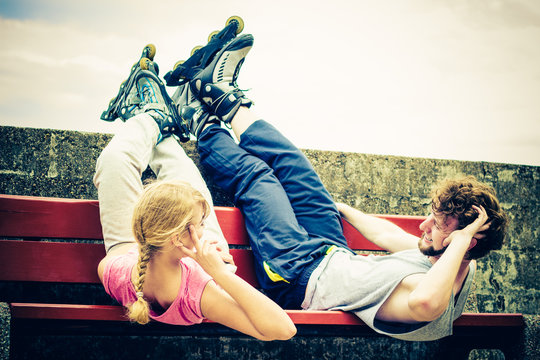 Young people friends relaxing on bench.