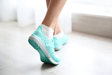 Woman wearing mint sneakers on blurred background