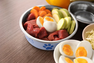 Healthy dog food on wooden background