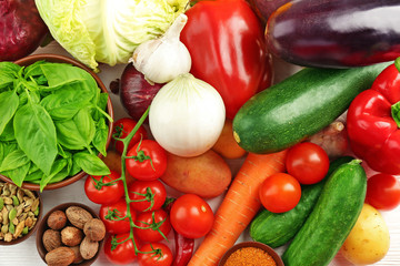 Vegetables and spices on wooden table, closeup