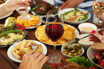 Friends eating and drinking wine in restaurant