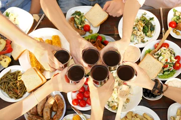 Washable wall murals Picnic Friends cheering with glasses of red wine on picnic