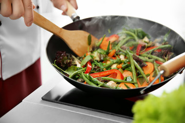 Mixing vegetables in pan closeup - obrazy, fototapety, plakaty